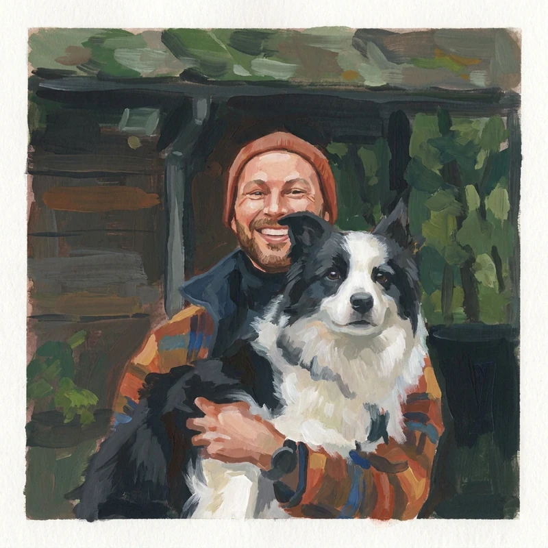 R. Berk with his border collie outside a cabin